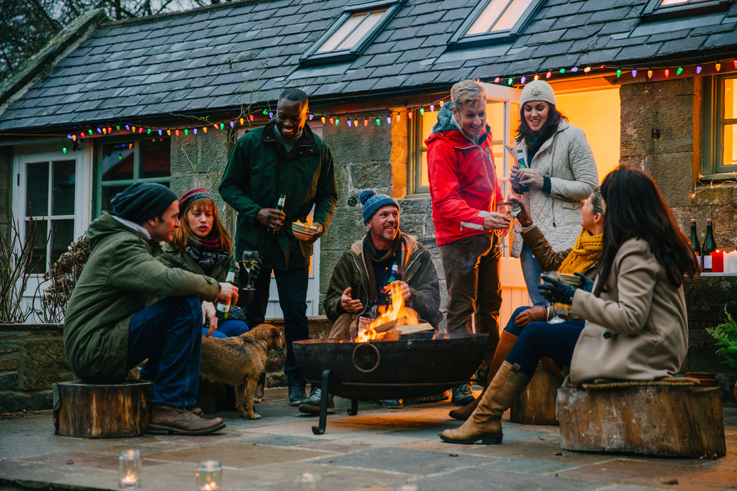 Group of Friends Sitting Around a Fire Pit